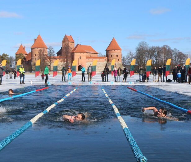 People take part in an annual winter swimming competition in freezing water, with temperature outside dropping to minus 3 degrees Celsius, on March 2, 2019 in Trakai, Lithuania.