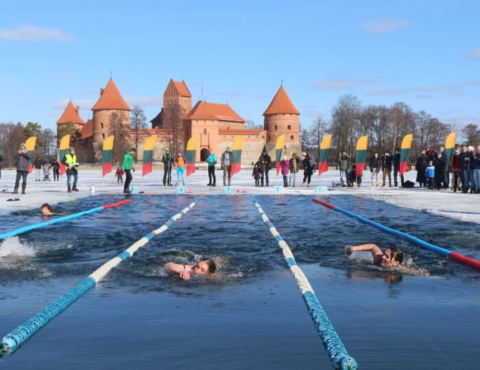People take part in an annual winter swimming competition in freezing water, with temperature outside dropping to minus 3 degrees Celsius, on March 2, 2019 in Trakai, Lithuania.